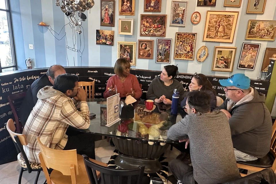 AHF local meetup - members in conversation around a café table